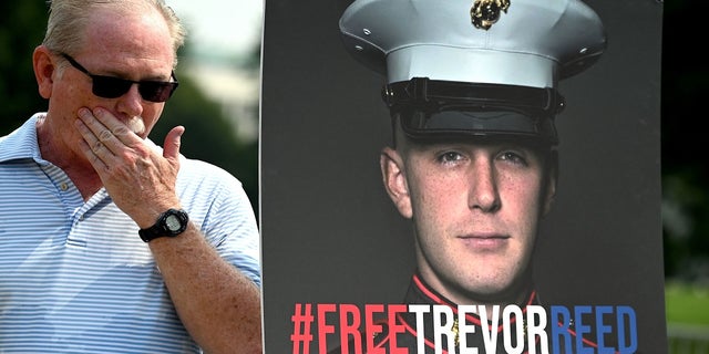 Joey Reed, the father of former U.S. Marine Trevor Reed, stands next to a placard of his son outside the U.S. Capitol in Washington, DC, on July 29, 2021, during a press conference. 