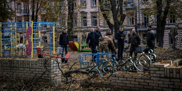 Emergency service personnel attend to the site of a blast next to a childrens playground in a park on October 10, 2022, in Kyiv, Ukraine. This morning's explosions, which came shortly after 8:00 local time, were the largest such attacks in the capital in months. 