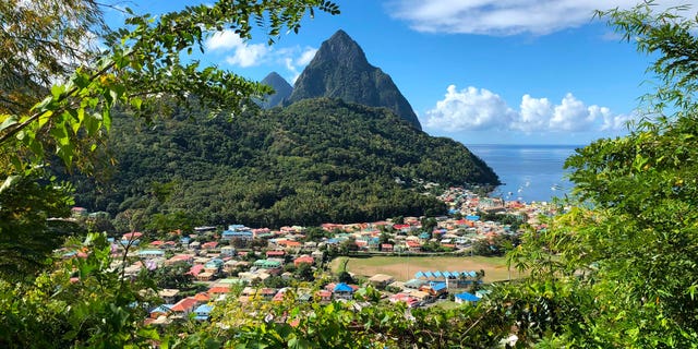 A British man was killed and one was wounded in a St. Lucia bar shooting late Saturday night. Pictured: A view of the Pitons, twin volcanic spires located in Saint Lucia. They are on a world heritage site which occupies an area of about 7,190 acres near the town of Soufriere, Saint Lucia.
