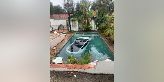 A Telsa with two adults and one child crashed and submerged into a Pasadena pool amidst California storms.