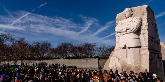Crowds gather to watch a wreath-laying ceremony at the Martin Luther King Jr. Memorial on Martin Luther King Jr. Day in Washington, on Jan. 16, 2023. 